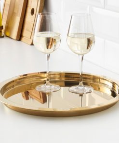 Two wine glasses on gold tray