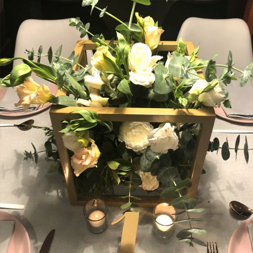 Gold metal cube with white roses