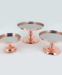 Three rose gold cake stands with mirrored bases