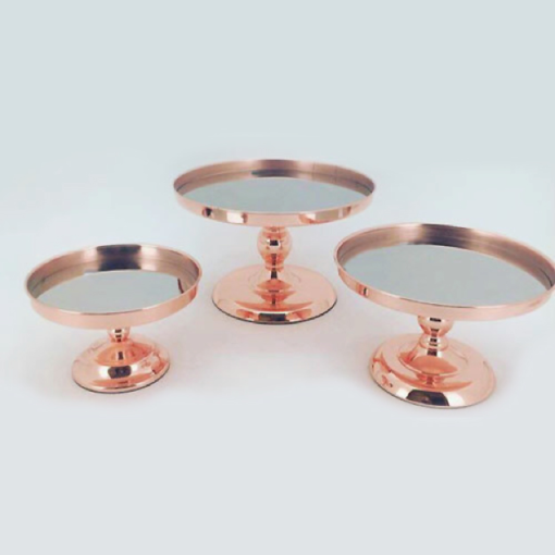 Three rose gold cake stands with mirrored bases