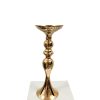 Gold Candlestick Holder sitting on plinth