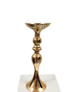 Gold Candlestick Holder sitting on plinth