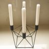 Black candle holder with 4 white tapered candles