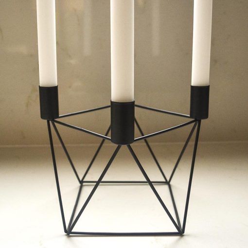 Black candle holder with 4 white tapered candles