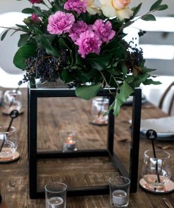 Black cube centerpieces with floral arrangement