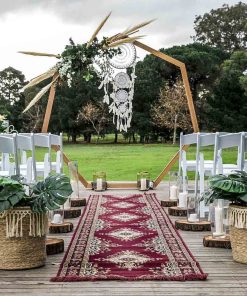 Heptagonal wedding arch in bohemian outdoor setting