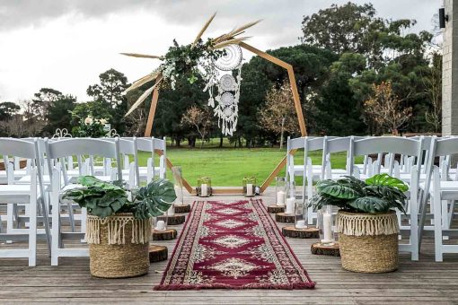 Heptagonal wedding arch in bohemian outdoor setting