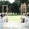 Tall metal gold display stands with floral arrangements