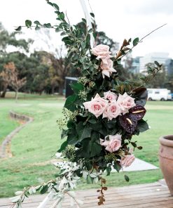 floral arrangement attached to white circular frame