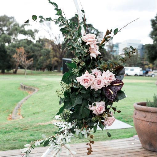 floral arrangement attached to white circular frame