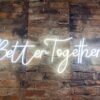 Better Together hanging Neon on Brick wall