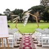 Bohemian style wedding ceremony with wooden arch