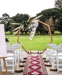 Bohemian style wedding ceremony with wooden arch