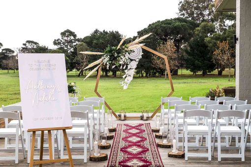 Bohemian style wedding ceremony with wooden arch