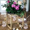 Gold cube metal centerpieces with flowers on table