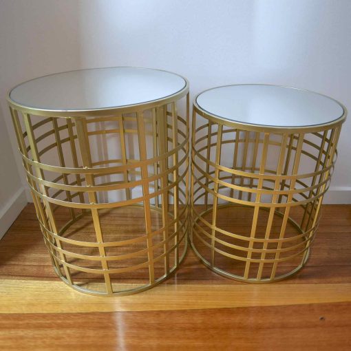 Two gold metal tables with glass tops