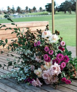 Tall metal gold display stands with floral arrangement at base