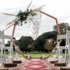 Heptagonal wooden arch with floral arrangement