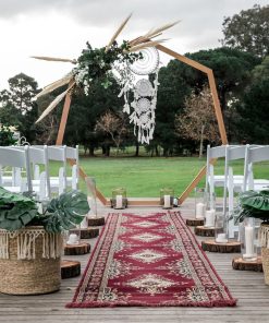 Heptagonal wedding arch in bohemian outdoor setting