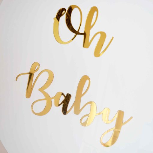 Gold mirrored glass letters that say Oh Baby