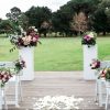 Pair of white Plinth Stands with floral arrangements