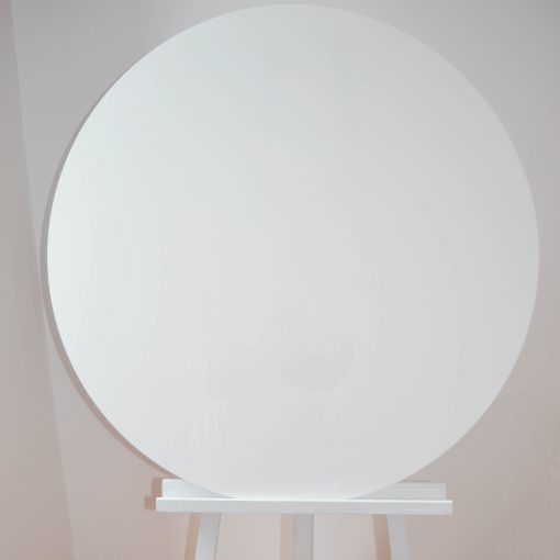 Large white circular board on white easel