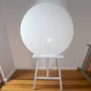 White circular board on white wooden easel