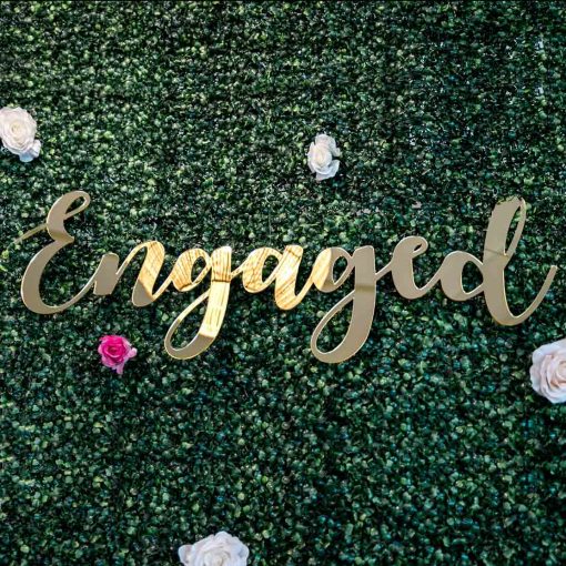 Engaged mirrored sign on green wall