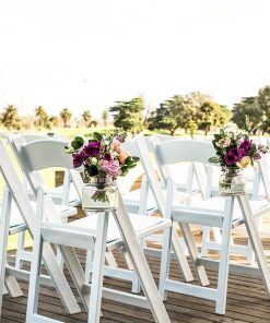 White americana chairs with flowers hanging from mason jars