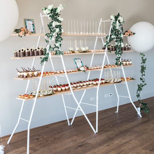 Tiered dessert shelving stand adorned with different dessert offerings