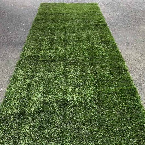 Green artificial turf aisle runner being used outdoors