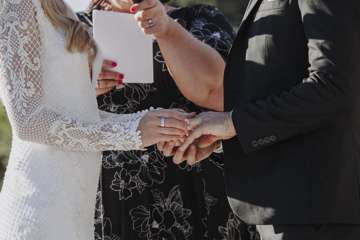 Couple exchanging rings at wedding ceremony