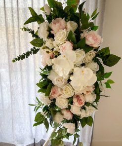 Garland of flowers hanging on arch in front of curtain