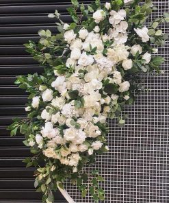 Faux flowers on white circular mesh backdrop screen