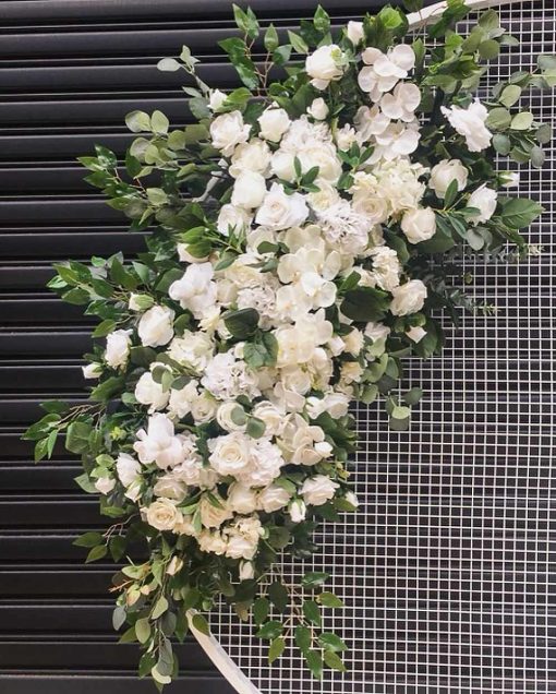 Faux flowers on white circular mesh backdrop screen